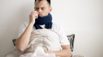sick person staying bed wrapped blanket