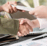Business people shaking hands, finishing up meeting. businessman giving money to his partner while making contract - bribery and corruption concepts. - Газета Магаданская правда